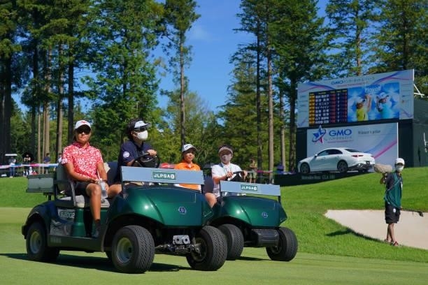 Mao Nozawa and Maiko Wakabayashi of Japan are taken to the 18th tee for the playoff first round following the final round of the GMO Internet Ladies...