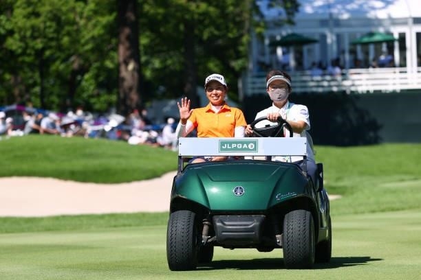 Maiko Wakabayashi of Japan waves as she is taken to the 18th tee for the playoff first round during final round of the GMO Internet Ladies Samantha...