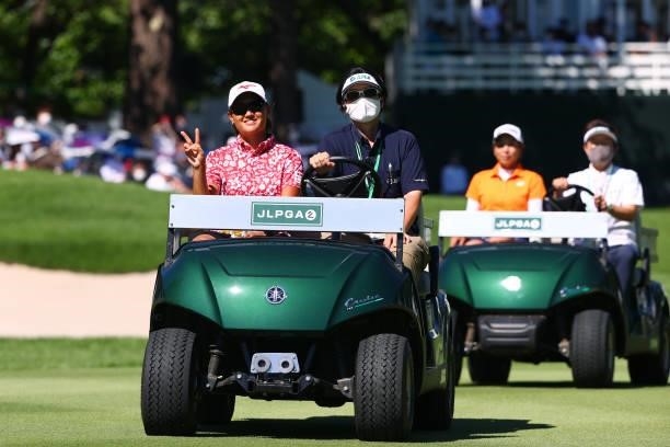 Mao Nozawa of Japan waves as she is taken to the 18th tee for the playoff first round during final round of the GMO Internet Ladies Samantha Thavasa...