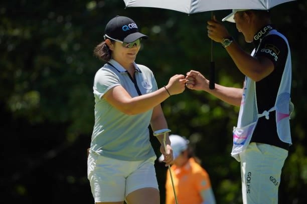 Min-young Lee of South Korea celebrates the birdie with her caddie on the 13th green during third round of the GMO Internet Ladies Samantha Thavasa...