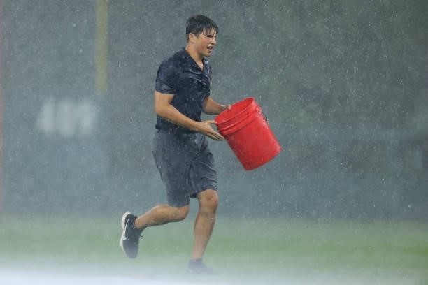 Philadelphia Phillies groundskeeper during a thunder storm that interrupted play during the tenth inning of a game against the Miami Marlins at...