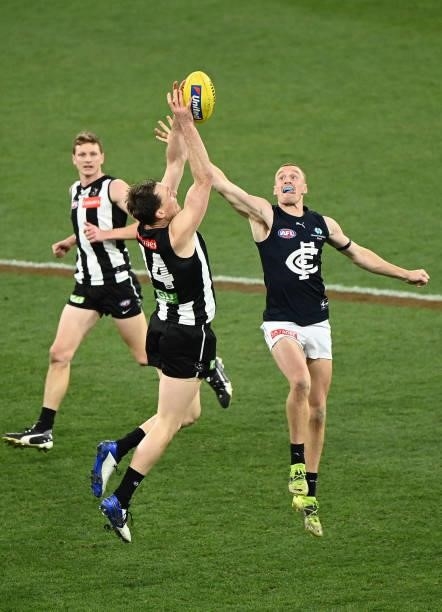 Jack Madgen of the Magpies Matthew Cottrell of the Blues compete for the ball during the round 18 AFL match between Collingwood Magpies and Carlton...