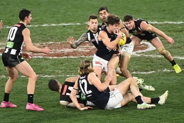Paddy Dow of the Blues is tackled by Jamie Elliott of the Magpies during the round 18 AFL match between Collingwood Magpies and Carlton Blues at...