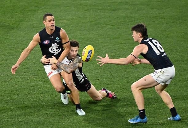 Ed Curnow of the Blues is tackled by Jamie Elliott of the Magpies during the round 18 AFL match between Collingwood Magpies and Carlton Blues at...