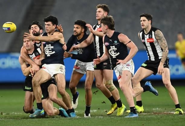 Matthew Kennedy of the Blues is tackled by Brodie Grundy of the Magpies during the round 18 AFL match between Collingwood Magpies and Carlton Blues...