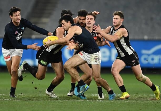 Matthew Kennedy of the Blues is tackled by Brodie Grundy of the Magpies during the round 18 AFL match between Collingwood Magpies and Carlton Blues...