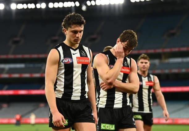 Trent Bianco and Callum L. Brown of the Magpies walk off after the Magpies were defeated by the Blues during the round 18 AFL match between...