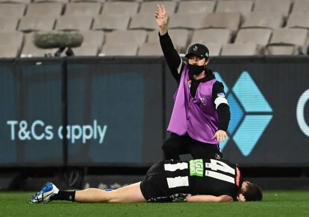 Brody Mihocek of the Magpies appears injured during the round 18 AFL match between Collingwood Magpies and Carlton Blues at Melbourne Cricket Ground...