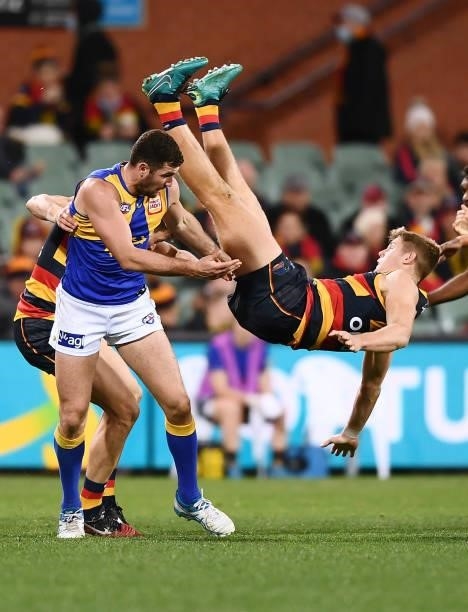 Nick Murray of the Crows flys high over Jack Darling of the Eagles but lands and injures himself during the round 18 AFL match between Adelaide Crows...