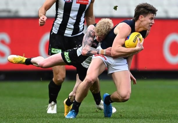 Sam Walsh of the Blues is tackled by John Noble of the Magpies during the round 18 AFL match between Collingwood Magpies and Carlton Blues at...
