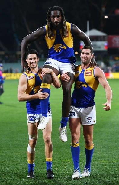 Nic Naitanui of the Eagles chaired off by Liam Duggan and Jack Darling of the Eagles for his 200th game during the round 18 AFL match between...