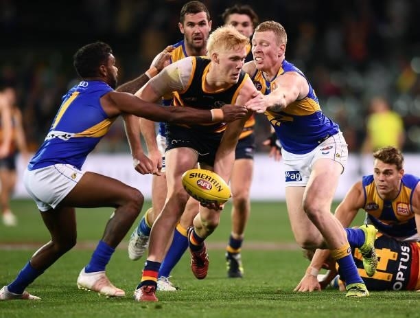 Elliott Himmelberg of the Crows tackled by Liam Ryan of the Eagles and Bailey J. Williams of the Eagles during the round 18 AFL match between...