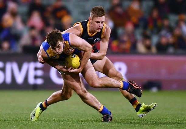 Jamie Cripps of the Eagles tackled by David Mackay of the Crows during the round 18 AFL match between Adelaide Crows and West Coast Eagles at...