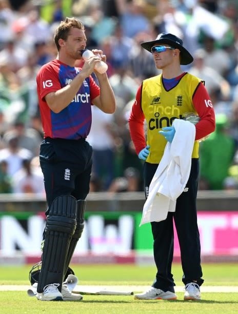 Jos Buttler of England takes a break for water from Eoin Morgan during the second Vitality International T20 match between England and Pakistan at...