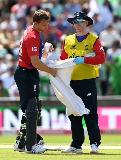 Jos Buttler of England takes a break for water from Eoin Morgan during the second Vitality International T20 match between England and Pakistan at...