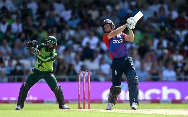 Jos Buttler of England bats watched by Pakistan wicketkeeper Mohammad Rizwan during the Second Vitality International T20 match between England and...