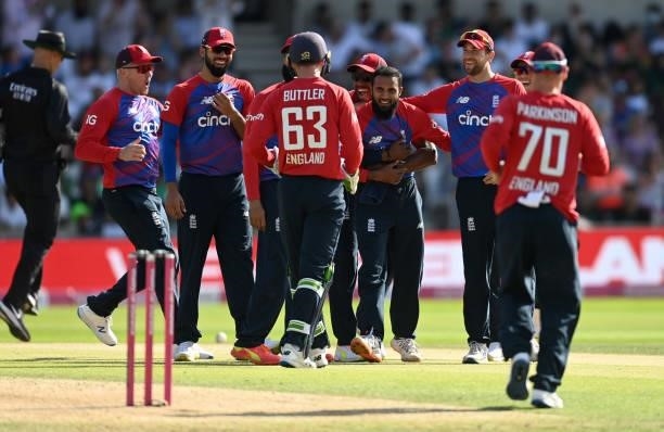 Adil Rashid of England celebrates with teammates after catching out Mohammad Rizwan of Pakistan from his own bowling during the Second Vitality...