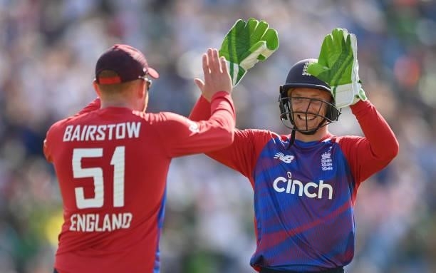 Jos Buttler and Jonny Bairstow of England celebrate after the dismissal of Mohammad Hafeez of Pakistan during the 2nd Vitality T20 International...