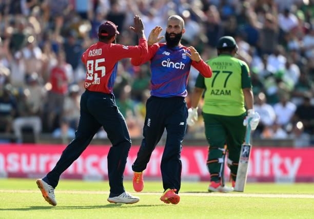 Moeen Ali of England celebrates with team mate Adil Rashid after taking a wicket during the second Vitality International T20 match between England...