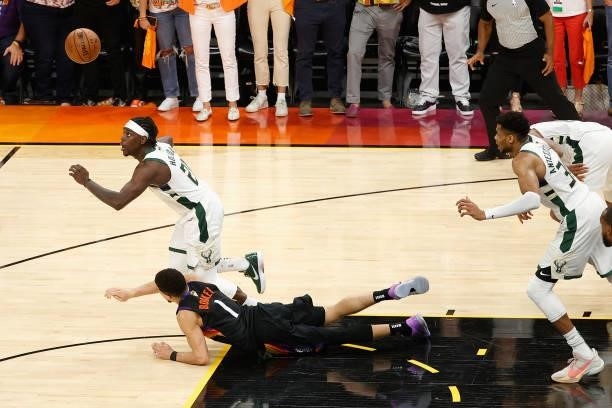 Jrue Holiday of the Milwaukee Bucks steals the ball from Devin Booker of the Phoenix Suns late in the second half of game five of the NBA Finals at...