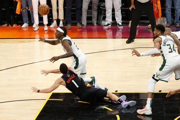 Jrue Holiday of the Milwaukee Bucks steals the ball from Devin Booker of the Phoenix Suns late in the second half of game five of the NBA Finals at...