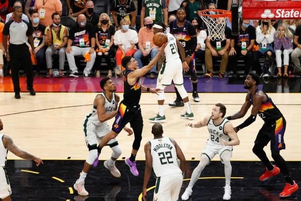 Devin Booker of the Phoenix Suns puts up a shot ahead of Giannis Antetokounmpo of the Milwaukee Bucks in the second half of game five of the NBA...