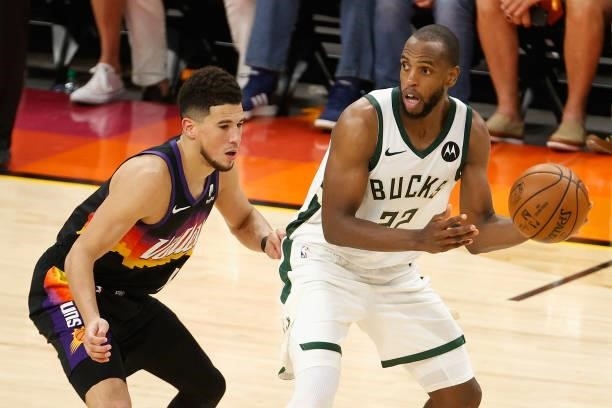 Khris Middleton of the Milwaukee Bucks looks to pass around Devin Booker of the Phoenix Suns in the second half of game five of the NBA Finals at...