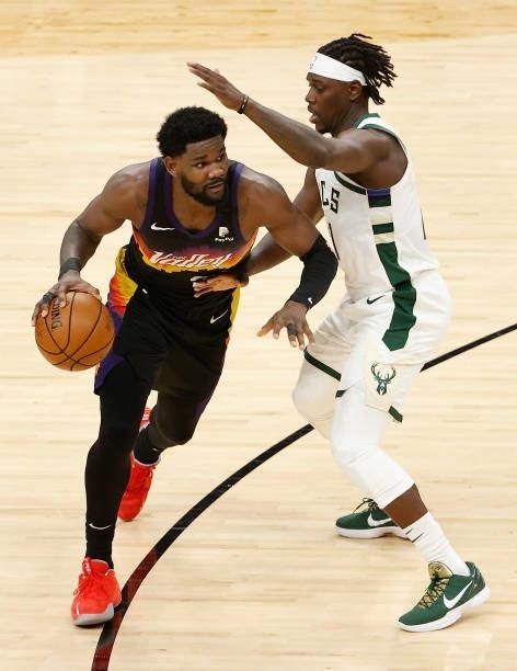 Deandre Ayton of the Phoenix Suns handles the ball against Jrue Holiday of the Milwaukee Bucks in the second half of game five of the NBA Finals at...