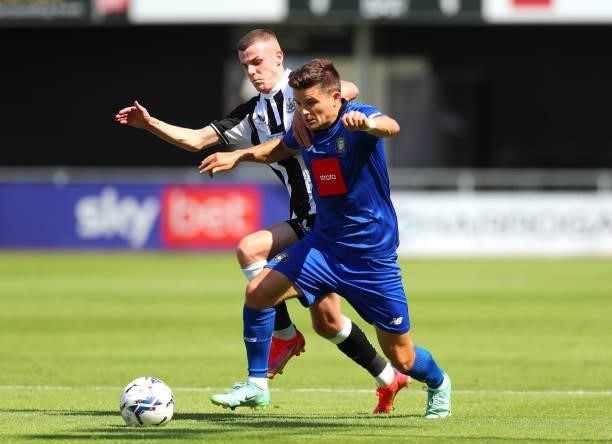 Josh Scott of Newcastle United and Ryan Fallowfield of Harrogate Town AFC battle for possession during the Pre-Season Friendly between Harrogate Town...