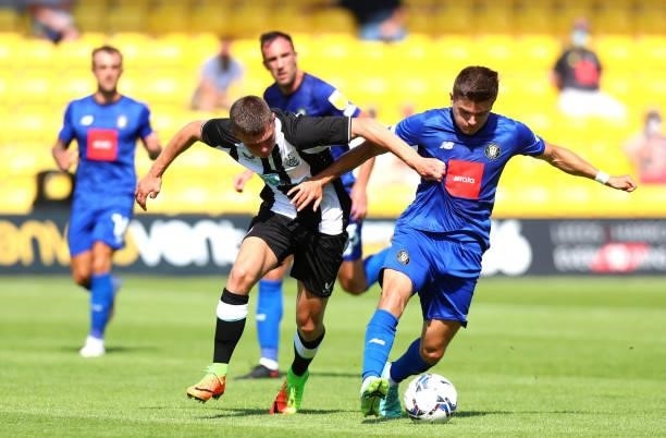 Jamie Miley of Newcastle United and Ryan Fallowfield of Harrogate Town AFC battle for the ball during the Pre-Season Friendly between Harrogate Town...