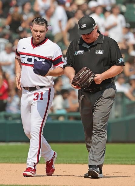 Umpire Bill Miller inspects the glove and hat of Liam Hendriks of the Chicago White Sox before he pitches the 9th inning against the Houston Astros...