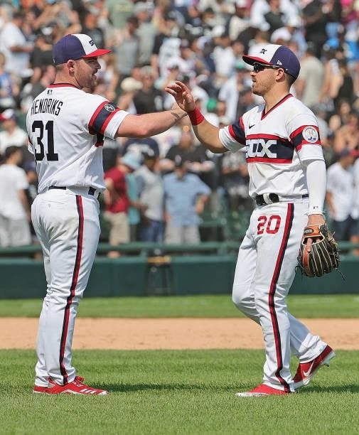 Liam Hendriks and Danny Mendick of the Chicago White Sox celebrate a win over the Houston Astros at Guaranteed Rate Field on July 18, 2021 in...