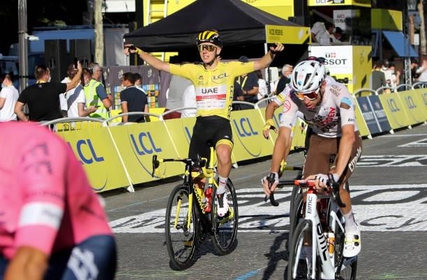 Race Leader's Yellow Jersey Tadej Pogacar of Slovenia and UAE Team Emirates crosses the finish line of final stage 21 of the 108th Tour de France...
