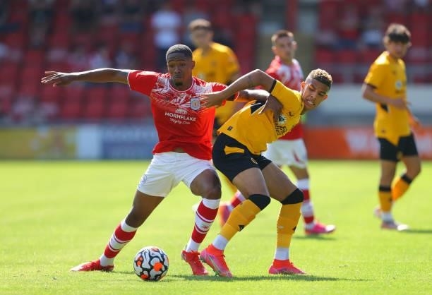 Chem Campbell of Wolverhampton Wanderers battles for the ball with Rio Adebisi of Crewe Alexandra during the Pre-Season friendly match between Crewe...