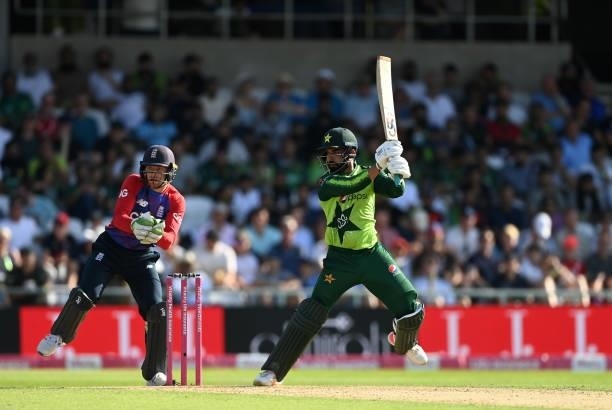 Shadab Khan of Pakistan bats watched by England wicketkeeper Jos Buttler during the Second Vitality International T20 match between England and...
