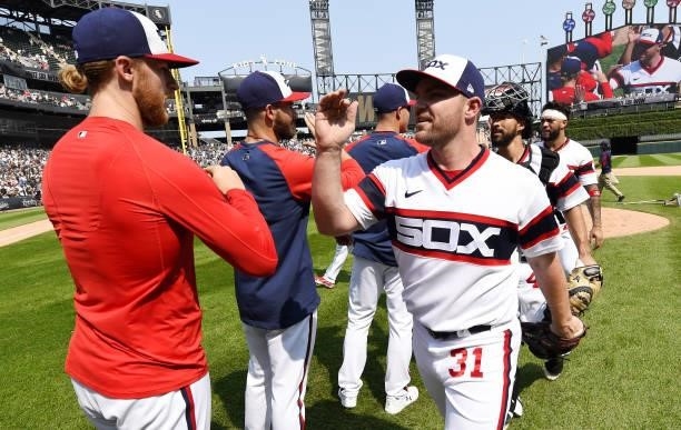 Liam Hendriks, Michael Kopech and members of the Chicago White Sox celebrate after the game against the Houston Astros on July 18, 2021 at Guaranteed...