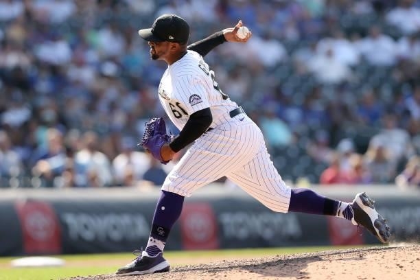 Pitcher Mychal Givens of the Colorado Rockies throws against the Los Angeles Dodgers in the tenth inning at Coors Field on July 18, 2021 in Denver,...