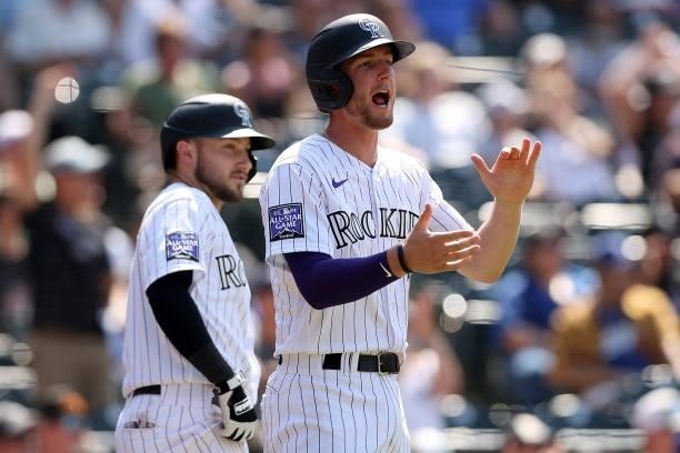 Ryan McMahon of the Colorado Rockies celebrates after scoring on a single by pinch hitter Matt Adams against the Los Angeles Dodgers in the seventh...