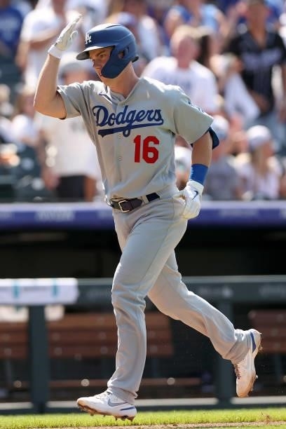 Will Smith of the Los Angeles Dodgers gestures as rounds third base after hitting a 2 RBI home run against the Colorado Rockies in the eighth inning...