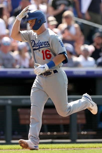 Will Smith of the Los Angeles Dodgers gestures as rounds third base after hitting a 2 RBI home run against the Colorado Rockies in the eighth inning...