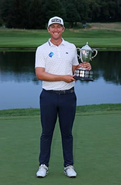 Seamus Power of Ireland poses with the trophy after putting in to win on the 18th hole during the sixth playoff hole during the final round of the...
