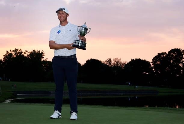 Seamus Power of Ireland poses with the trophy after putting in to win on the 18th hole during the sixth playoff hole during the final round of the...