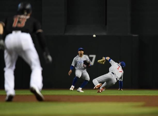 Kris Bryant of the Chicago Cubs cannot make a diving catch on a fly ball hit by Daulton Varsho of the Arizona Diamondbacks during the fifth inning at...
