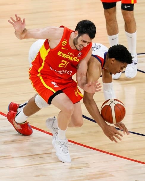 Keldon Johnson of the United States fouls Alex Abrines of Spain as they go after a loose ball during an exhibition game at Michelob ULTRA Arena ahead...