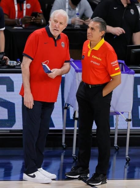 Head coach Gregg Popovich of the United States talks with head coach Sergio Scariolo of Spain before an exhibition game at Michelob ULTRA Arena ahead...