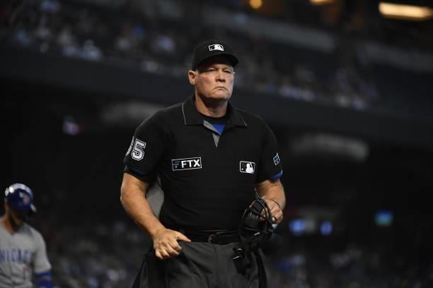 Home plate umpire Ted Barrett walks over to watch a replay during a game between the Arizona Diamondbacks and Chicago Cubs at Chase Field on July 17,...