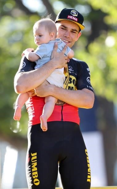Wout van Aert of Belgium and Jumbo - Visma holding his 7 months year old son Georges van Aert celebrates during the trophy ceremony winning the final...