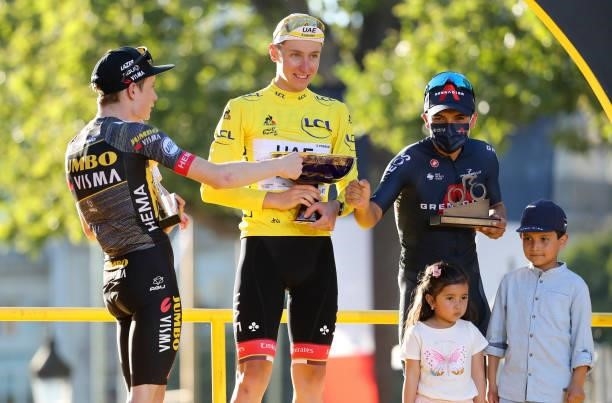 From left, second place of the Tour Jonas Vingegaard of Denmark and Jumbo - Visma , winner's Yellow Jersey Tadej Pogacar of Slovenia and UAE Team...