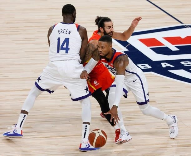 Damian Lillard of the United States uses a screen by teammate Draymond Green to get away from Ricky Rubio of Spain during an exhibition game at...