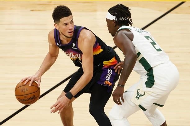 Devin Booker of the Phoenix Suns handles the ball against Jrue Holiday of the Milwaukee Bucks in the second half of game five of the NBA Finals at...